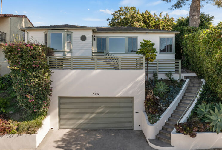 exterior of a traditional home painted white with olive details
