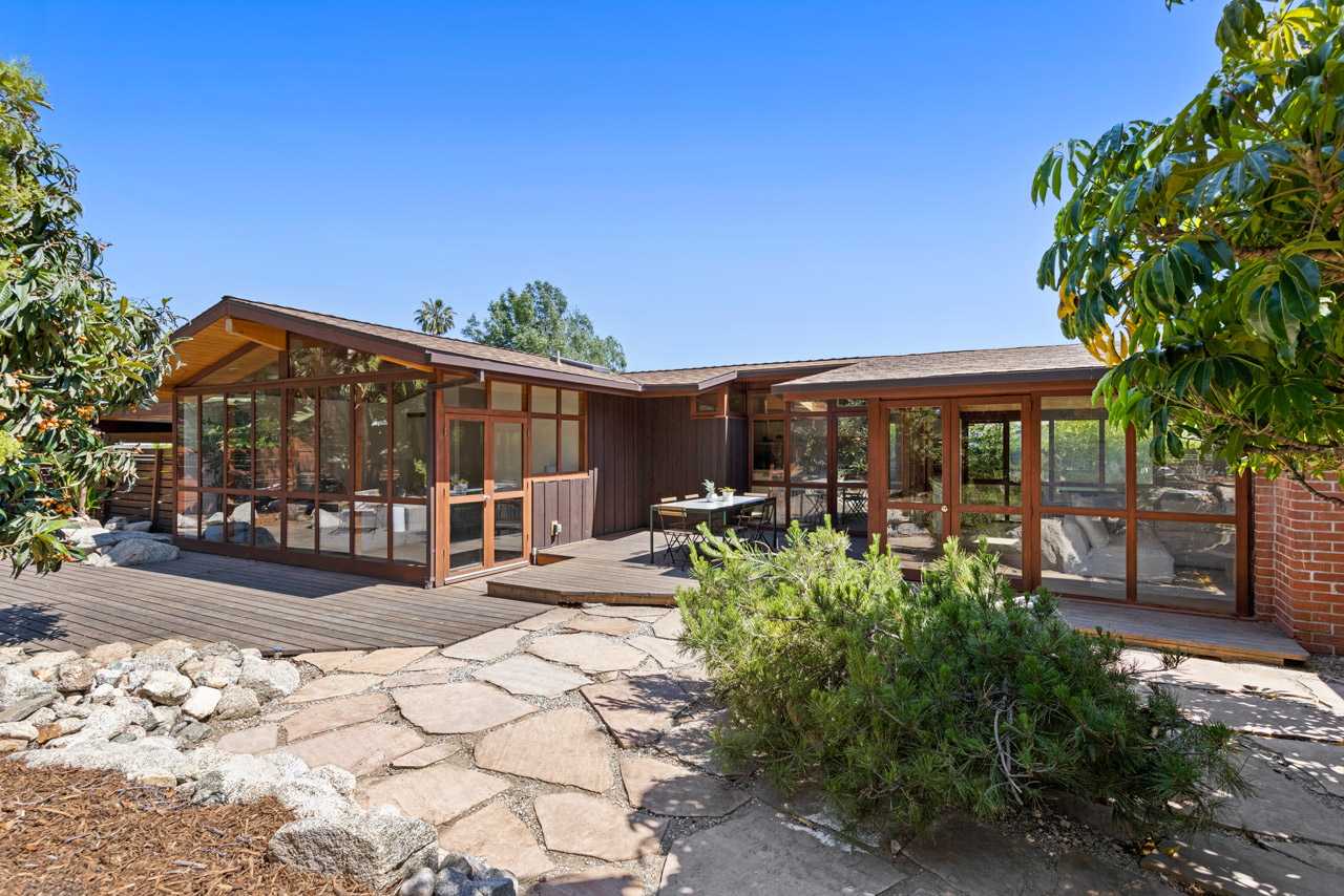 a low midcentury ranch home in wood with windows