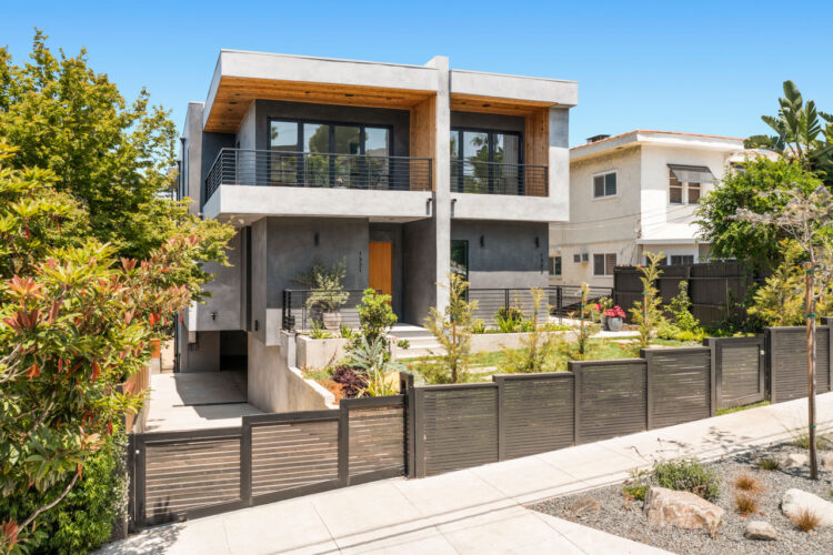 exterior of a contemporary grey TIC property with wood details and a wood fence