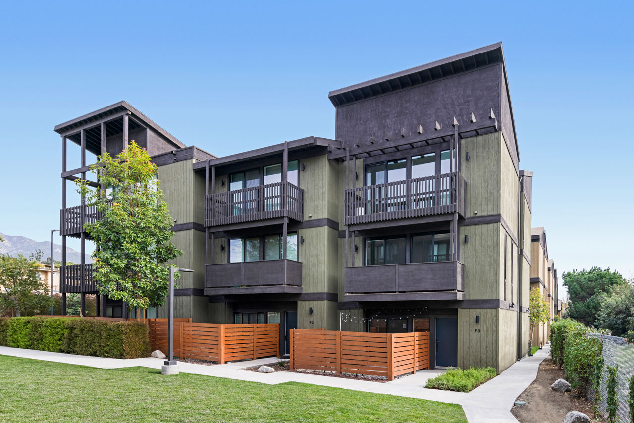 exterior of a green and dark brown craftsman townhome