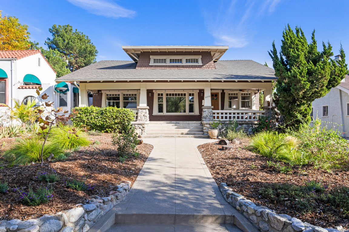 exterior of a craftsman bungalow painted brown with white accents