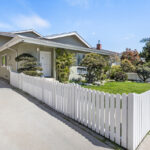 exterior of a traditional home with a white picket fence and green grass in Sawtelle Los Angeles