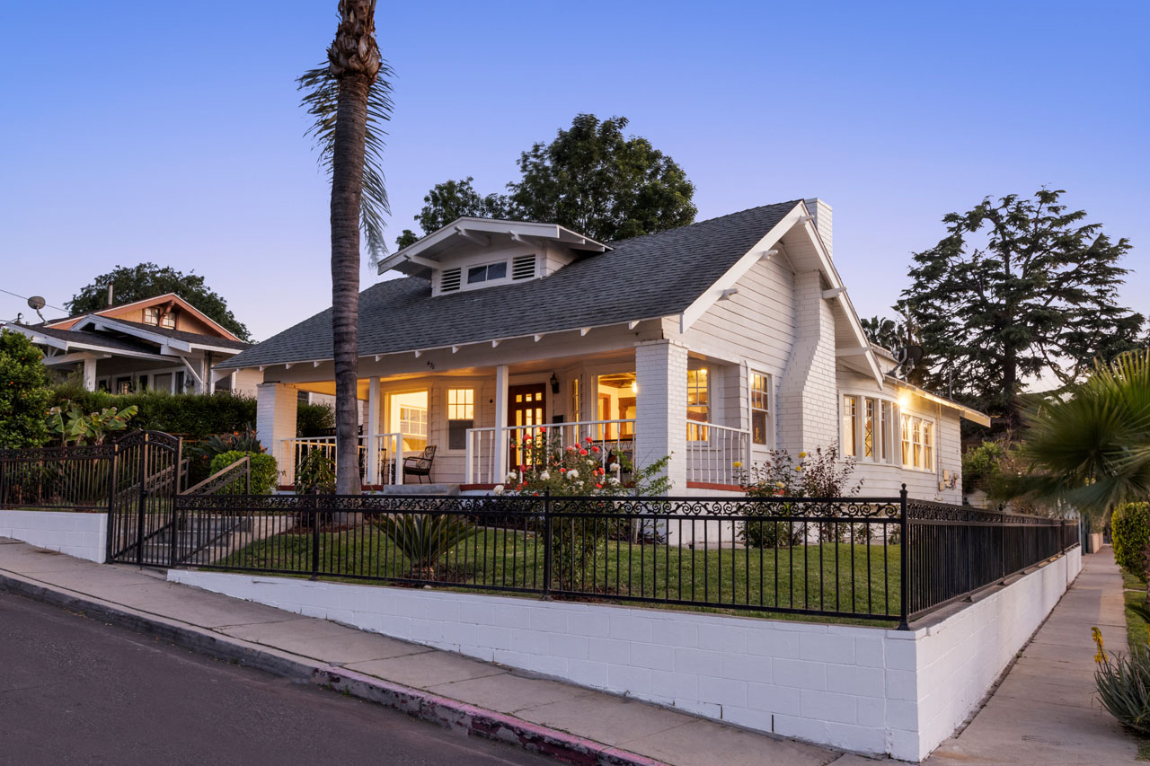 exterior of a white craftsman style home in highland park at twilight