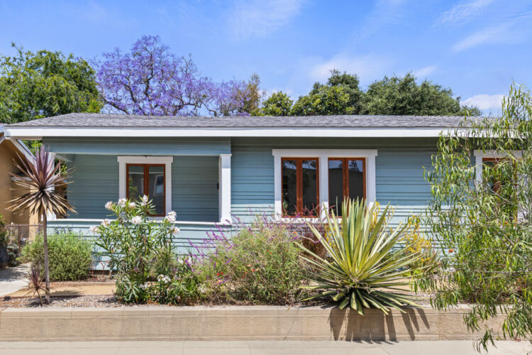 exterior of a traditional highland park home painted blue with white trim and brown windows