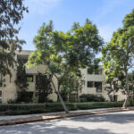 exterior of the white house a three story condo building with green trees in west hollywood