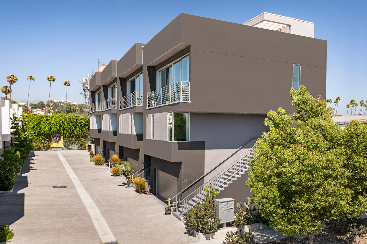 exterior of a small lot single family home in atwater village the image shows contemporary homes 3 stories, grey and dark grey with windows and foliage