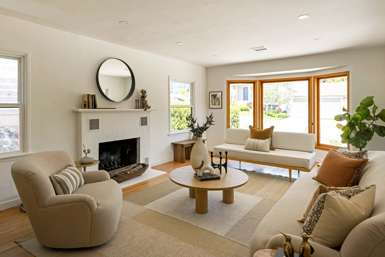 interior of a home with bay windows and a fireplace beige colors
