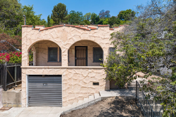 exterior of a spanish style home with red beige exterior and tile roof