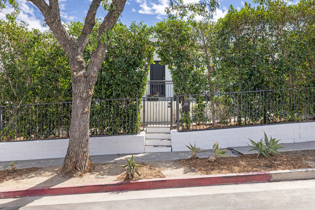 exterior of a tradtional home painted white with black trim