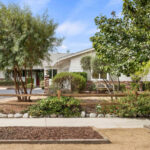 Exterior of a ranch style home with drought tolerant landscaping