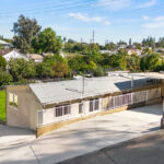 exterior of a beige traditional one story home with green backyard