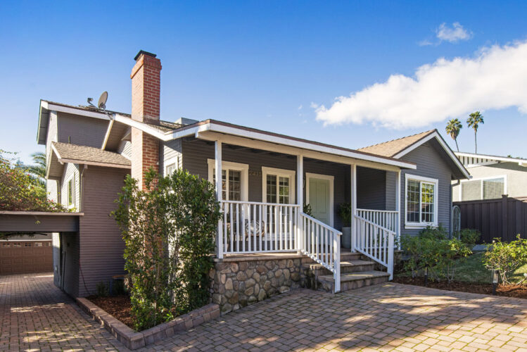 exterior of a traditional home painted blue with white trim