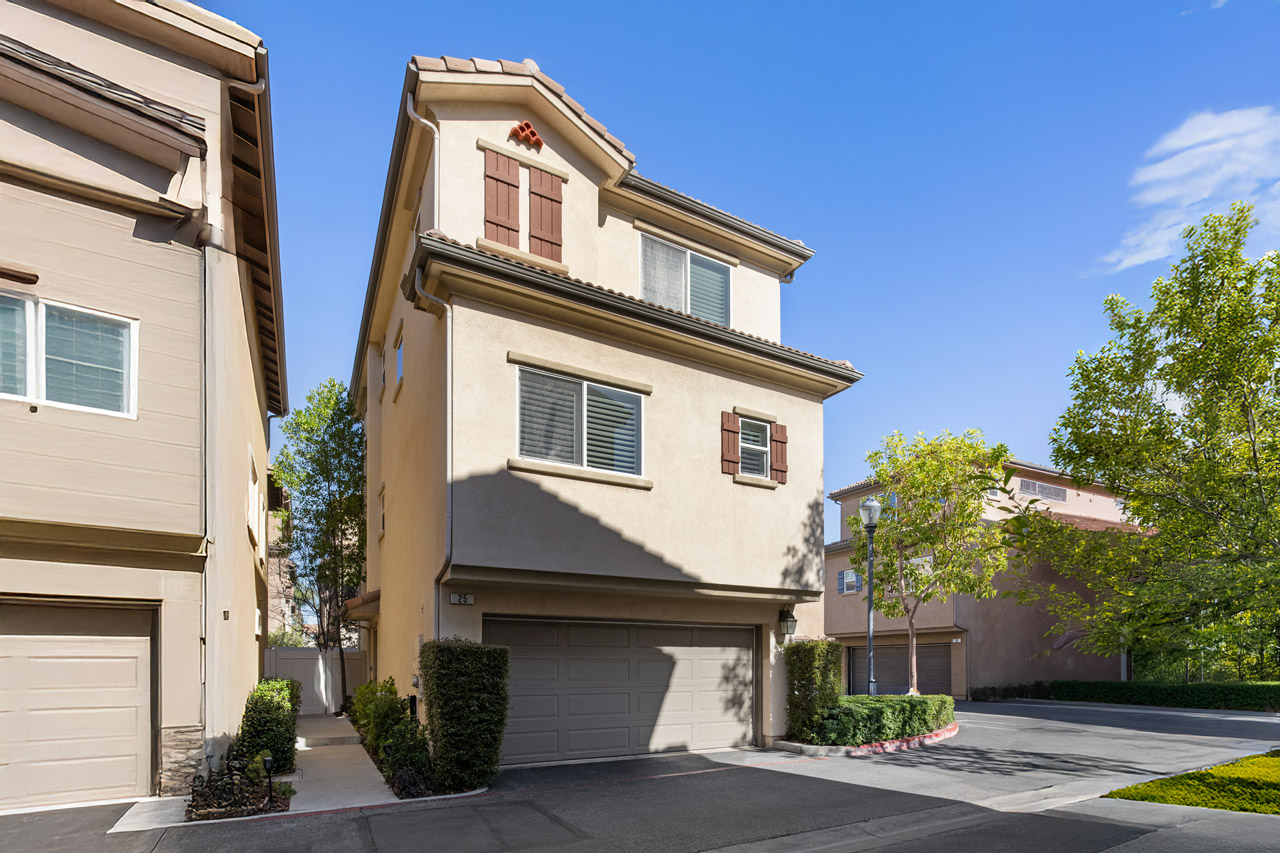 exterior of a three story townhouse home, contemporary Spanish style with tile roof