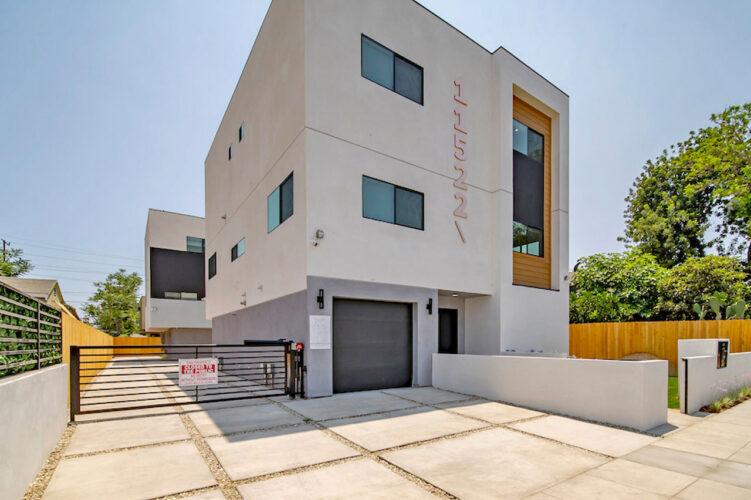 exterior of a three story contemporary townhome building, white yellow with grey details