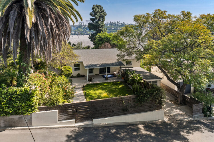 drone image of a traditional home with view of dodger stadium and palm trees
