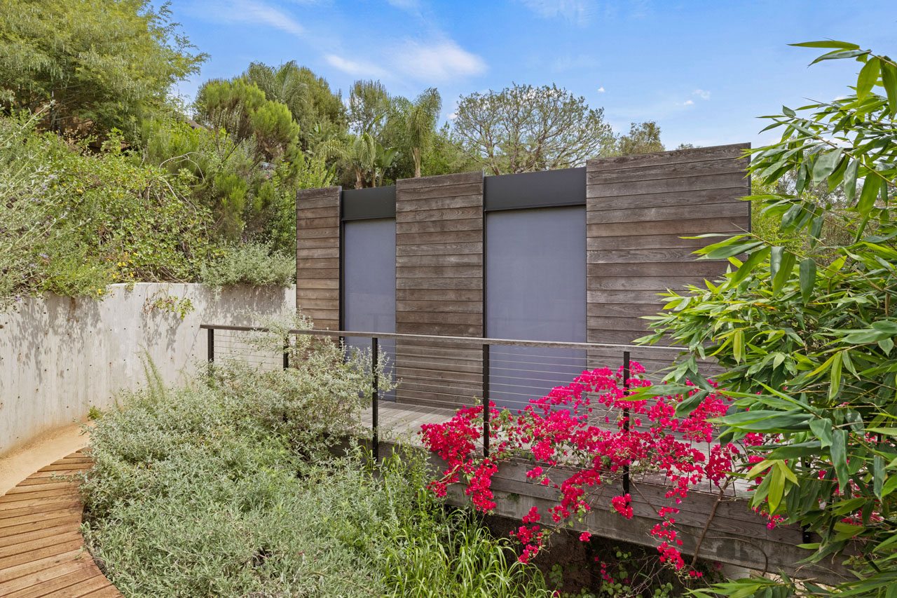 exterior of a modern contemporary adu designed and built by cover in Silver Lake, a modernist style building with wood cladding and pink bougainvillea