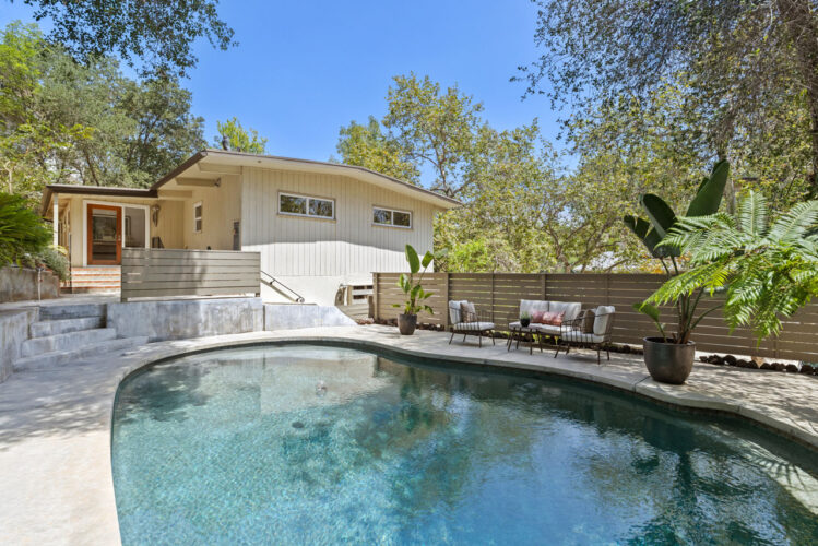 exterior of a mid century home with pool
