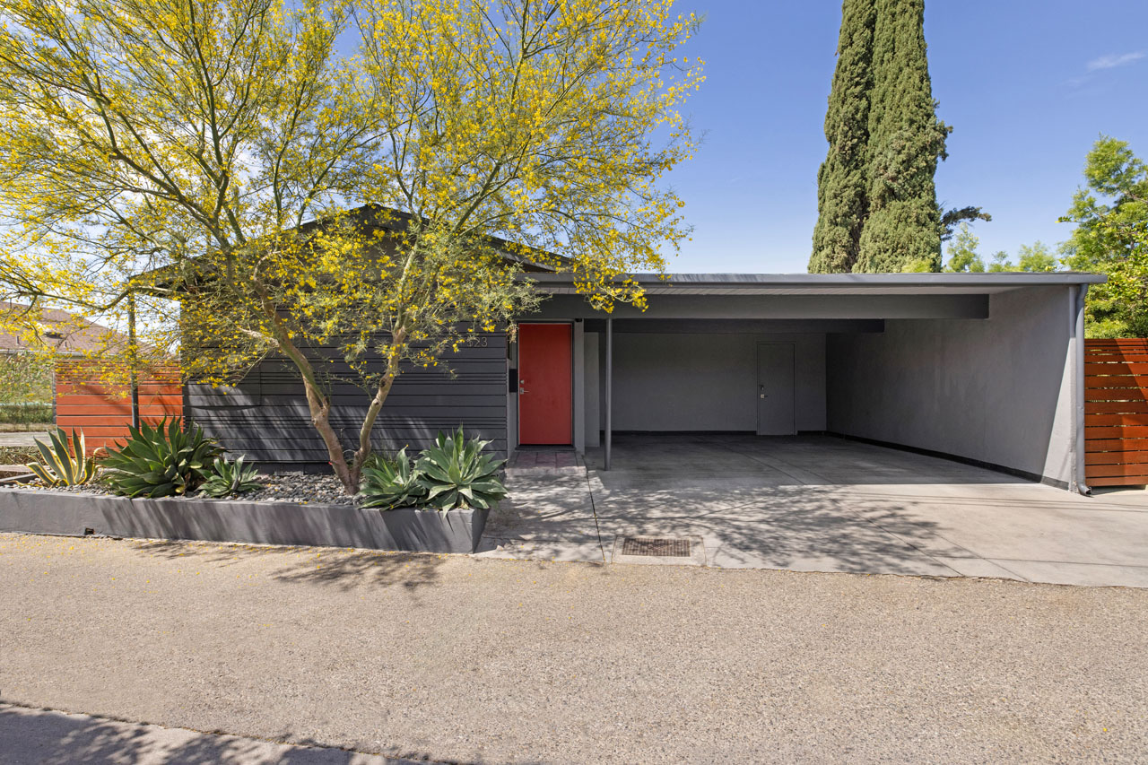 front exterior of a two story mid century home painted in greys with spiral staircase and jacuzzi