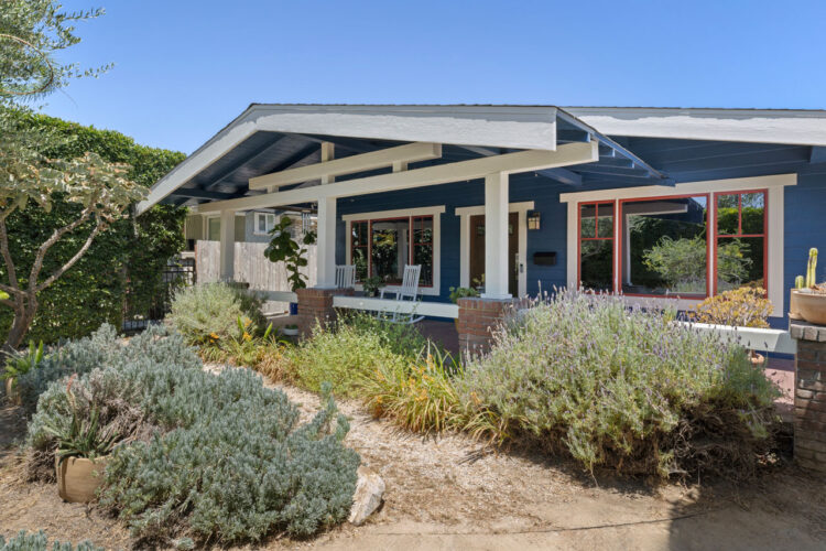 exterior of a california bungalow style home painted blue with white trim and drought tolerant landscaping
