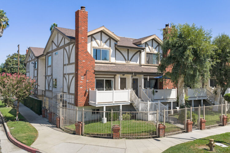 13959 Victory Blvd #1 91401 Valley Glen Townhome exterior showing a tudor style three story home with brown trim and red brick chimney