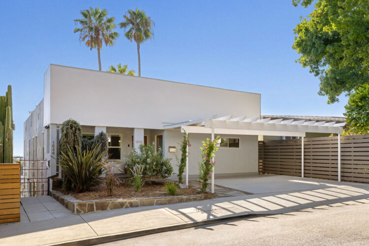 1642 Elevado St Silver Lake exterior of a modernist duplex style home painted white with green palm trees and blue sky