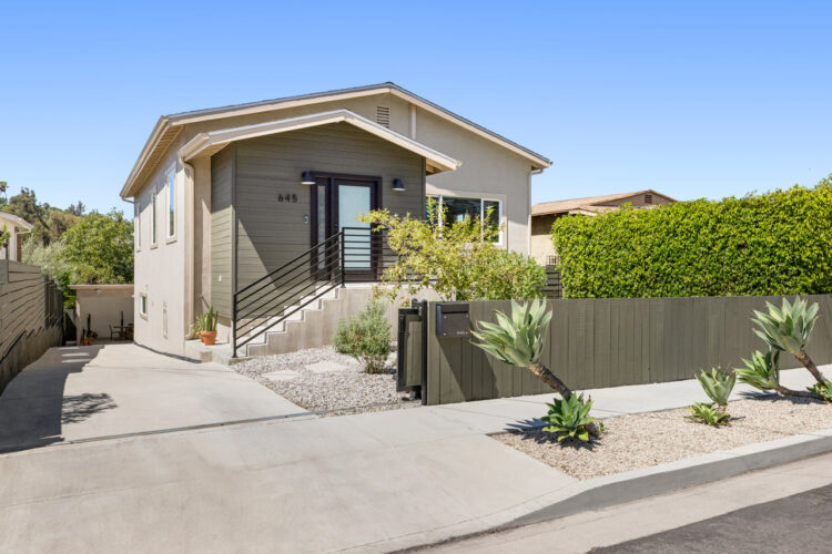 645 Milo Ter Highland Park exterior image of a contemporary home with grey smooth stucco and dark grey wood fence and agave