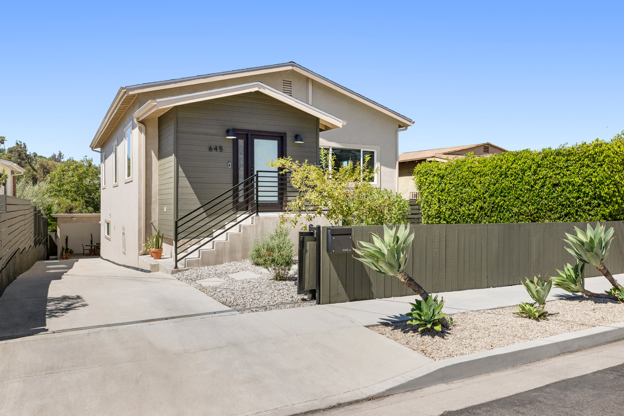 645 Milo Ter Highland Park exterior image of a contemporary home with grey smooth stucco and dark grey wood fence and agave