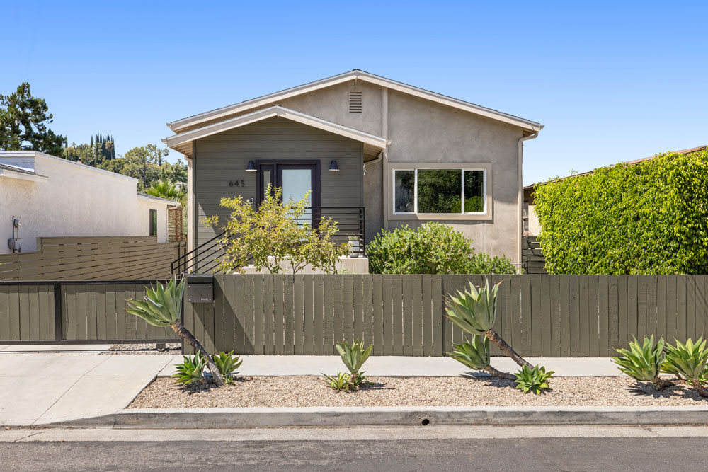 645 Milo Ter Highland Park exterior image of a contemporary home with grey smooth stucco and dark grey wood fence and agave