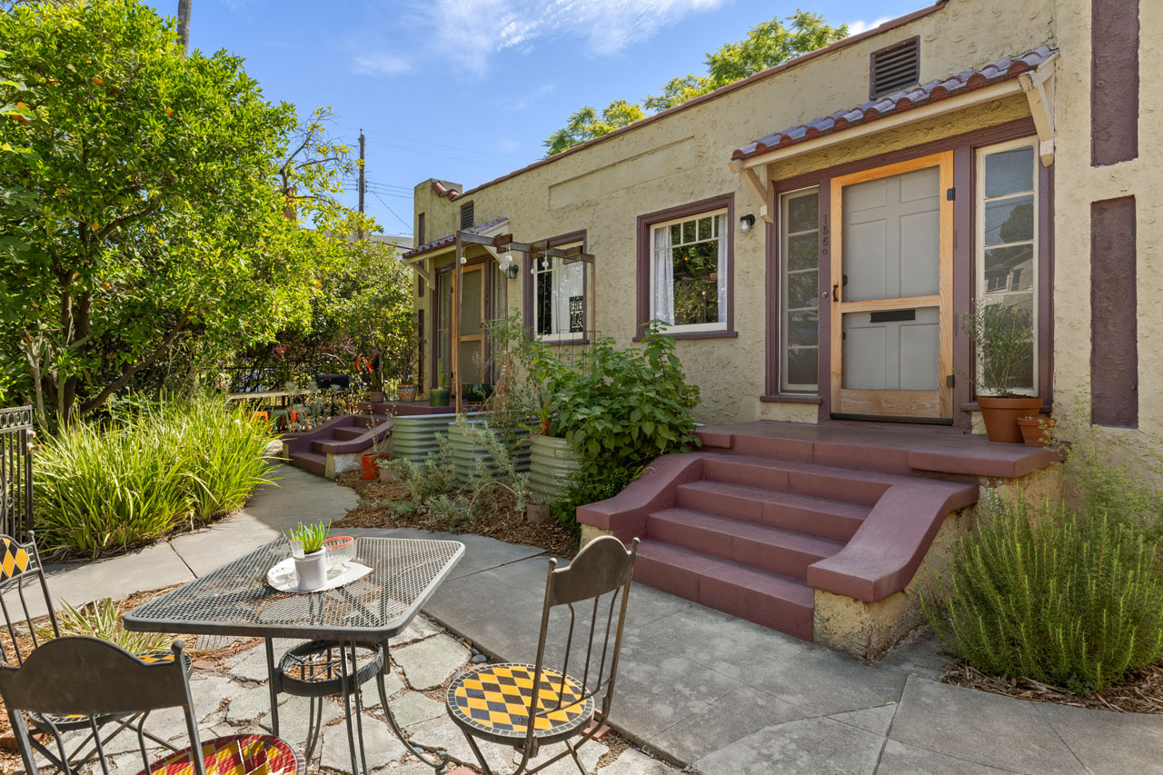 1560 Morton Ave Echo Park exterior of a spanish style duplex painted green with maroon stairs and trim