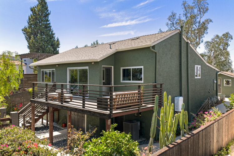 853 Tipton Ter Highland Park 90042 image of a green bungalow style home at twilight with brown wood deck and cacti