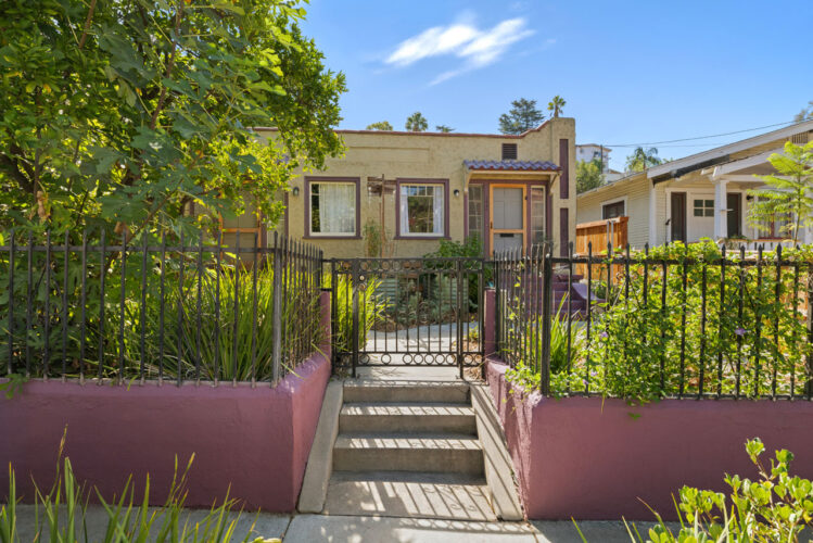 1560 Morton Ave Echo Park exterior of a spanish style duplex painted green with maroon stairs and trim