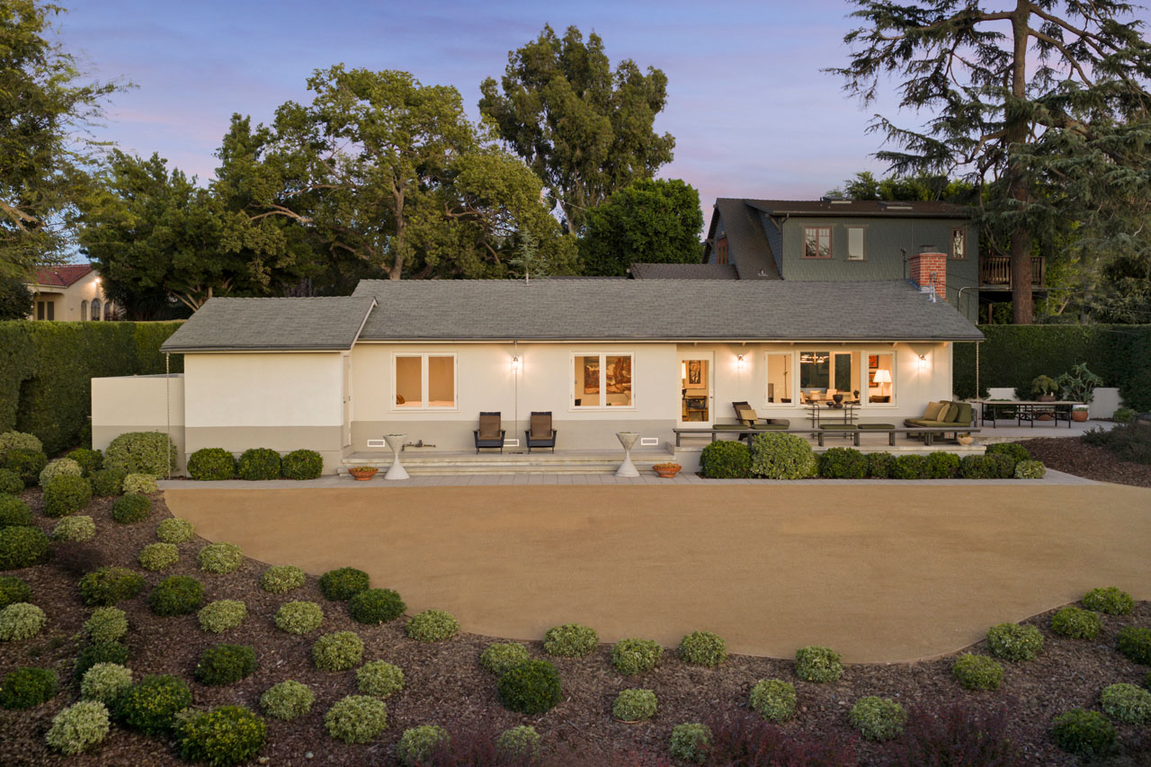 838 Elyria Dr 90065 image of a ranch style house at twilight painted white with dg yard and plantings