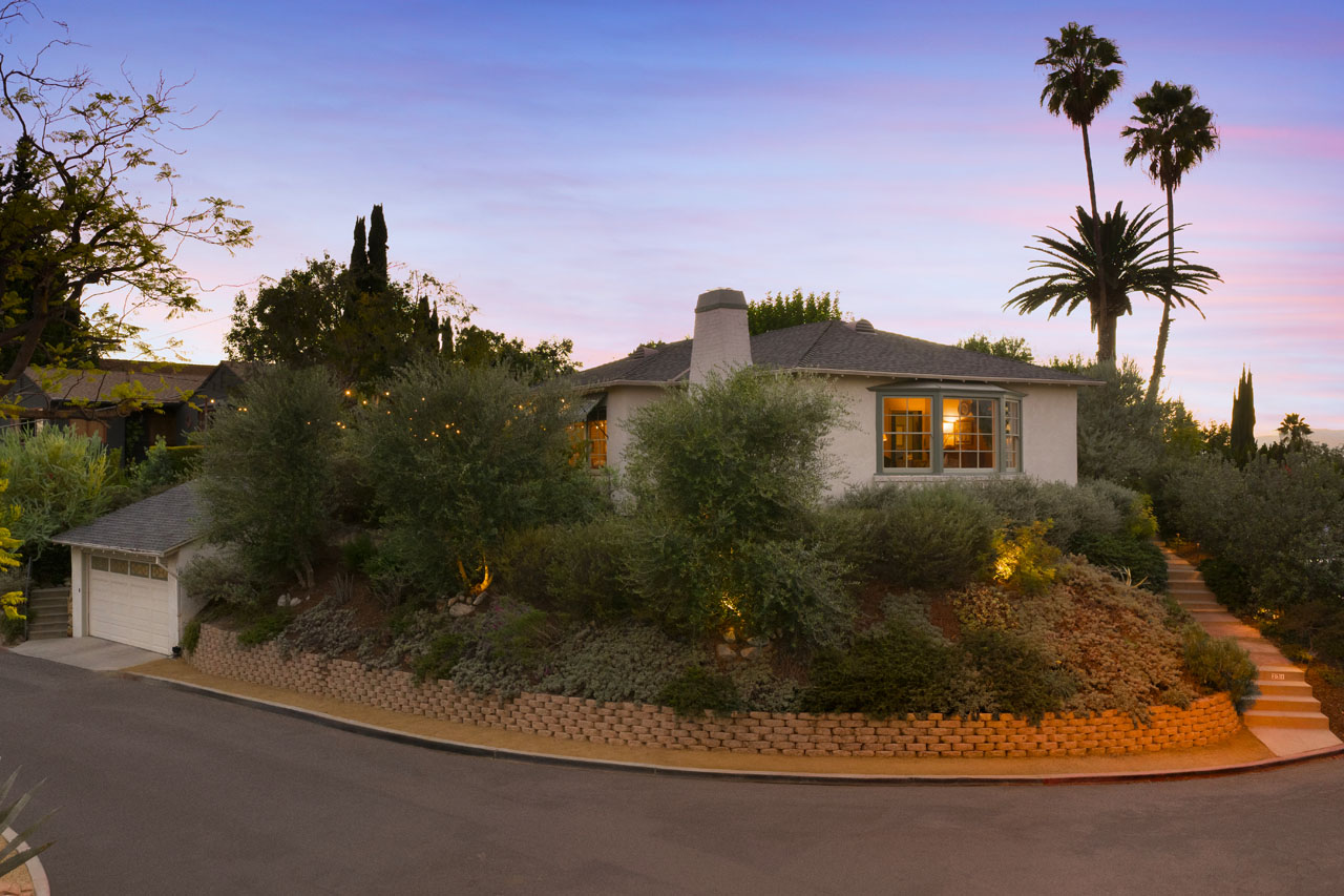 231 Wayland St 90042 Highland Park image of a traditional home on a corner lot at twilight with palm tree silhouette