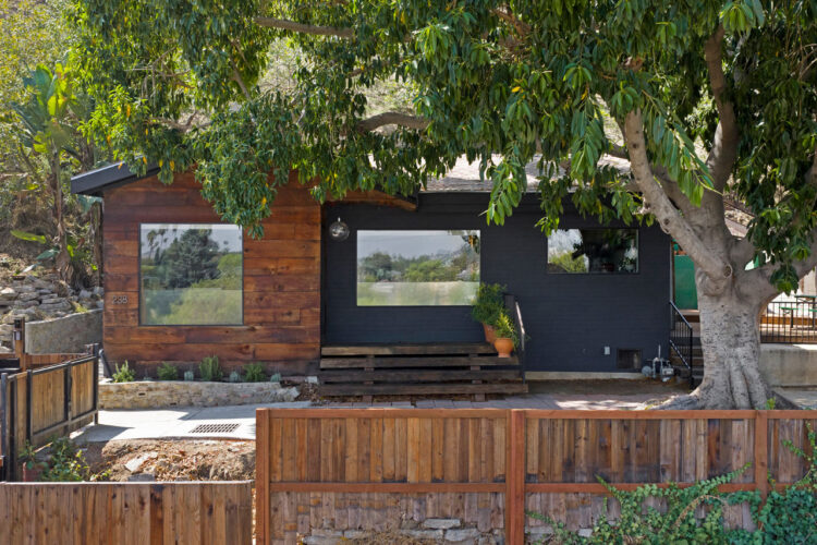exterior of a california bungalow with wood details and black graphite facade