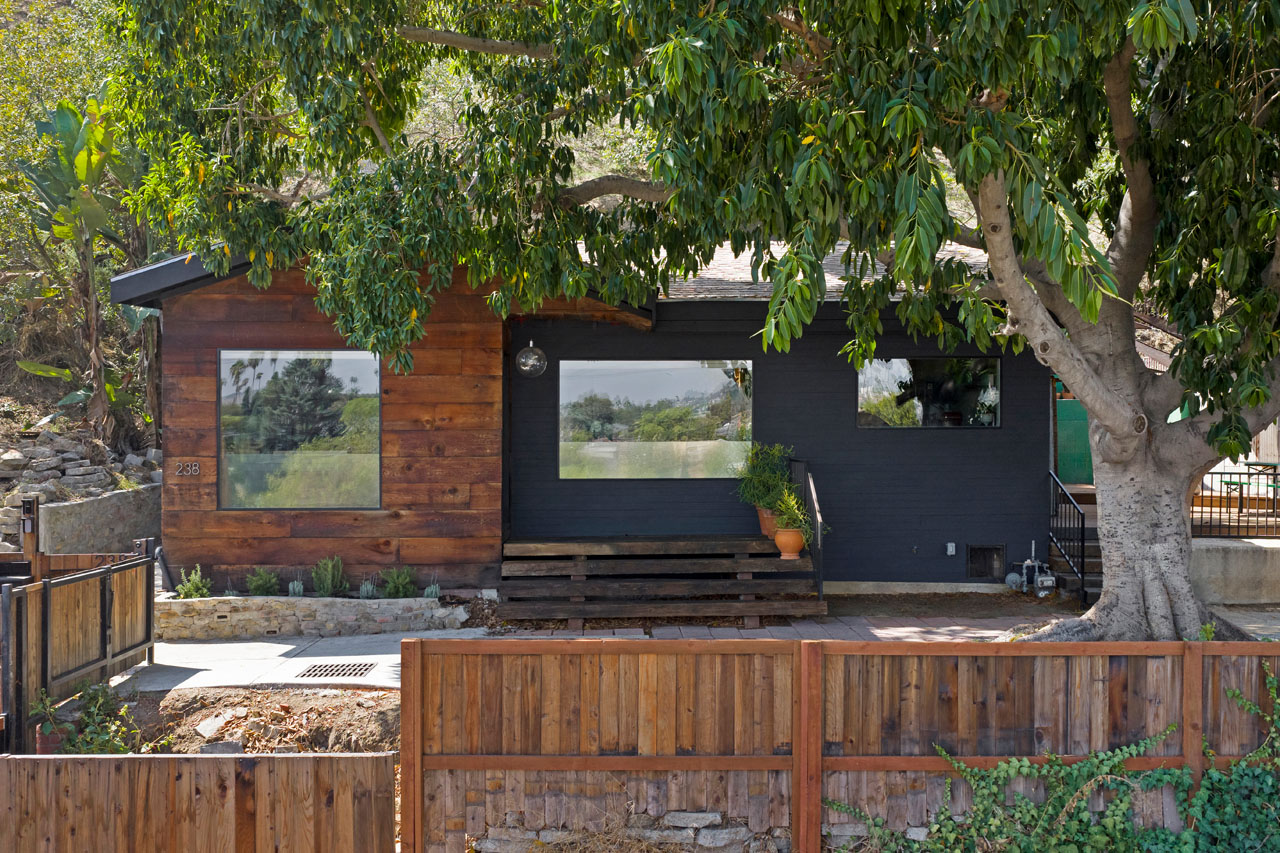 exterior of a california bungalow with wood details and black graphite facade
